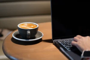 coffee at work next to laptop